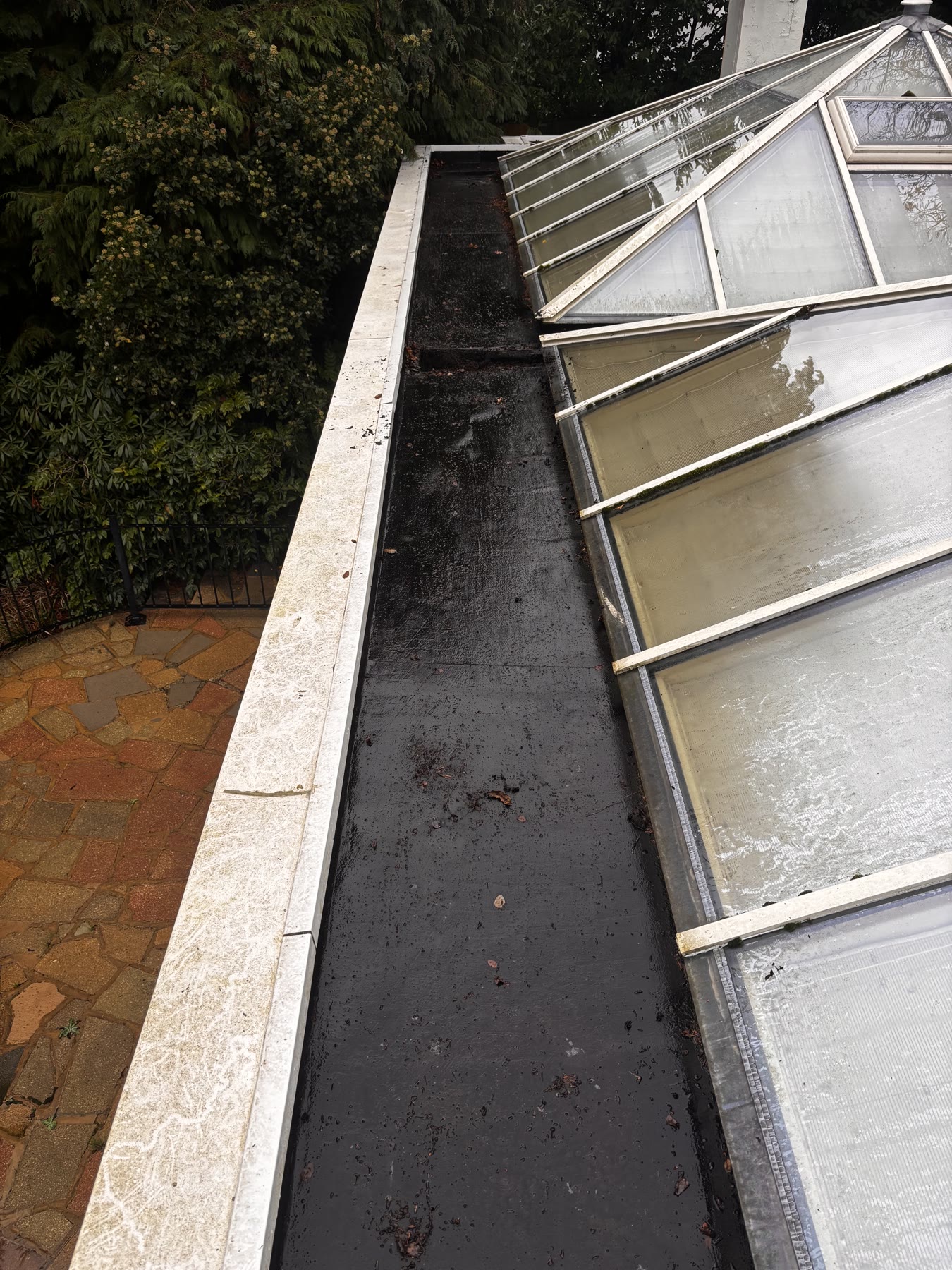 Gutter beside a conservatory after clearing